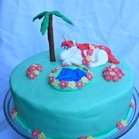 Hawaiian Unicorn The request was for a Hawaiian Unicorn cake. I added a palm tree, flowers draped on the unicorn, a pond, and flower patches. The birthday...