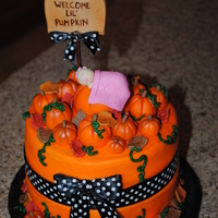 Pumpkin Patch Baby! Cake for a fall baby girl! Really loved how this cake came out. Pumpkins and baby are all fondant, with fondant fall leaves for the border...
