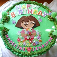Dora The Explorer 1St Birthday Cake This is a 4 layer cake with alternating vanilla and chocolate layers, chocolate pudding filling, buttercream icing, fondant character...