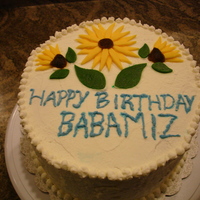 Maple Walnut Ice Cream Cake An ice cream cake made with french vanilla cake and maple walnut ice cream. Covered in whipped cream and decorated with fondant flowers.