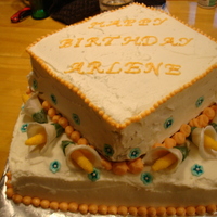 Square Birthday Cake Two tiered square birthday cake made with chocolate cake, peanut butter filling and butter-cream icing. Decorated with fondant and gum...