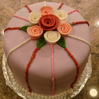 Rolled Rose Cake This was a dark chocolate cake with peanut butter filling. It was covered in marshmallow fondant with fondant roses and accents in icing.