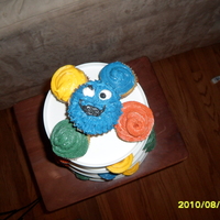 Elmo Elmo face with Sesame Street Sign with Birthday Boy name and age. Cookie Monster cupcake.
