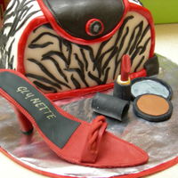 My First Purse Cake Devil food cake covered with ganache. Outter covering is MMF. Gum paste shoe and make-up. This was my first time working with ganache,...