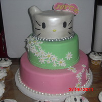 Hello Kitty Dominican Cake, 2 top tier strawberry banana filling, bottom tier Pineapple filling, covered in MMFondant, ears in rice krispies, flowers...