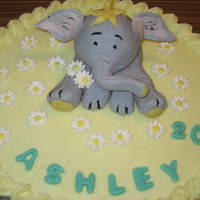Elephant And Daisies Round double layer buttercream frosted cake with elephant made of fondant and gumpaste and daisies.
