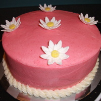 Pink Cake With Daisies Lemon cake with lemon curd filling, daisies in fondant. Covered with a strawberry/white chocolate ganache (from CC recipies.)