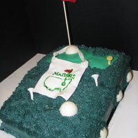 Masters Golf Cake My aunt asked me to make her a golf cake with Masters badge. Everything but the flag pole is edible! :) The Golf Balls are chocolate. The...