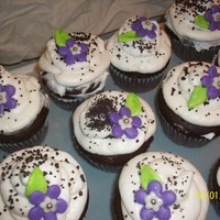 Chocolate Cupcake chocolate cake with pecan praline filling, fondant flowers.made for my husbands job.everyone loved them.please leave comments. i'm new...