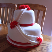 First Wedding Cake My first ever wedding cake that I ever made! Im really proud of this cake. I made all the red gumpaste roses myself of course. Had a bit of...