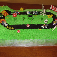 Mario Kart Cake Vanilla cake with buttercream icing and fondant track/figures