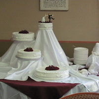 Our First Wedding Cake My wife and I made this cake with buttercream(white) icing and white cake with strawberry/cream cheese filling, with red silk flowers in...