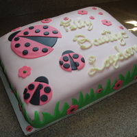 Pink & Green Ladybug Birthday/baptism Lemon Cake with fresh Raspberry filling and cream cheese icing. Covered in MMF and all decorations are MMF. This cake was for a little girl...