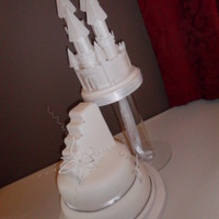 Fairy Princess Castle Wedding Cake Based on a previous design (source unknown), fairy princess castle suspended above a two tier chocolate sponge cake iced in white fondant...