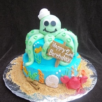 Octopus Birthday Cake Tropical Sunset flavored cake w/ pineapple cream cheese filling and coconut flavored buttercream. RKT octopus with fondant and gumpaste...