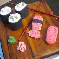 Sushi I had such a fun time making this cake! Sushi is MM wrapped in MMF and the rice are sprinkles. This was my first time covering a square...