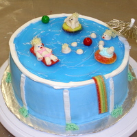 Swimming Pool Cake My first swimming pool cake, the water was made with piping gel, the swimmers are made from buttercream.