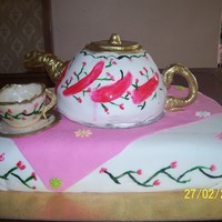 Teapot And Cup Teapot shaped cake of sponge covered with fondant. Cake moulded out of marzipan and dusted with pearl dust. The base cake is vanilla sponge...