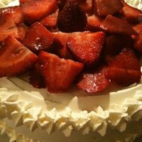 Strawberry Cake Iced with whipped cream, fresh strawberries on top