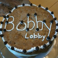 Double Doozie Cookie Cake 2 layers of chocolate chip cookie cake with cream cheese frosting in the middle.