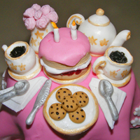 Tea For 2 Fondant tea party (atop a texas muffin) to celebrate a little girl's 2nd birthday party, hence the two candles on the cake! Tiny and...