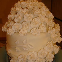 White Wedding Cake 2-8" rounds with fondant. Gumpaste roses and accents.
