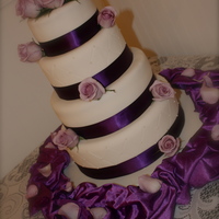 Violet Hues This client wanted a simple but elegant cake for her wedding. It is a four tier french vanilla cake with raspberry cream cheese filling....