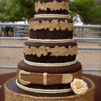 Western Wedding Cake. I was asked to make this cake for an outside western themed wedding. Its made of chocolate fondant with white cake and cream cheese filling...