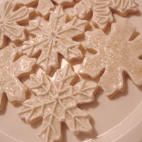 Snowflake Sugar Cookies snowflake sugar cookies with a icing glaze and decorated with opal sugar crystals and royal icing. Enjoy!