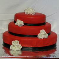 Red/black/white Oval Red 3 Tier Oval Wedding CakeBottom layer - Devil's Food Chocolate; Middle Layer - Swiss Chocolate; Top Layer - White; covered in...