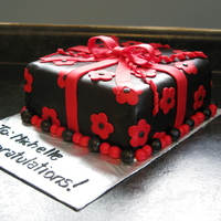 Black & Red Gift Cake Chocolate MMF tinted black with red fondant bow/flowers. White cake with raspberry filling