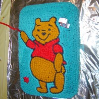 Pooh This cake is covered in buttercream frosting and entirely freehand.
