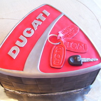 Ducati Cake This is a huckleberry champagne cake with huckleberry filling. It is hand sculpted to look just like the ducati logo and the owner's...