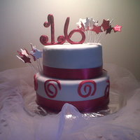 Red And White Sweet 16 2 layer chocolate cake covered in MMF the stars and #16 was made from gumpaste and covered in red and white disco dust.