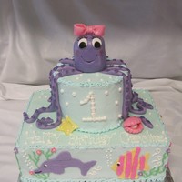 Under The Sea Octopus Cake Under the sea themed cake. Octopus topper is rice krispy treats covered in fondant. The legs, starfish, and clam with pearl are made out of...