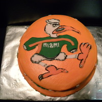 University Of Miami Two tiered chocolate cake with buttercream icing and fondant accents. Mascot is hand carved with fondant.