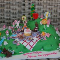 Fairy Picnic The cake is devil's food with chocolate ganache, covered in fondant. All details are made of fondant, except for the lollipops.