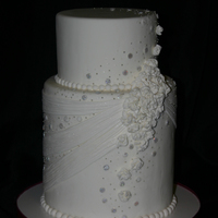 Wedding Dress Inspired Fondant covered 6" and 8" rounds with handmade fondant accents. Cake was inspired by the wedding dress.