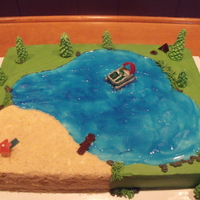 A Day At The Lake This was a birthday cake I did for a woman who loved to take her pontoon out on the lake. I used piping gel and food color for water....