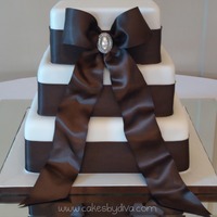 Jessica's Wedding Cake This is a wedding cake that I made last week. The bride requested brown satin ribbon (which was a pain to find in 2.5 inch). The bottom...
