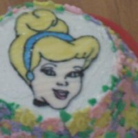 Small Cinderella Colorflow With Royal Icing Flowers 9 inch Cinderella cake covered sides with royal icing flowers. Cake sparkles on top of cake.