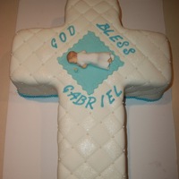 God Bless Gabriel WASC w/raspberry filling, buttercream, and MMF. Fondant baby, pacifier, and blanket. Made for my nephew's baptism.
