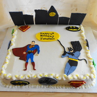 Justice League Cake Vanilla cake with chocolate filling. All decor are made of either gum paste or fondant. I traced the superman and batman on gumpaste and...