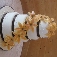 Lily Wedding Cake This is my third wedding cake I have done. The lilies are wired gumpaste flowers that are dusted and dotted with edible marker. The bottom...