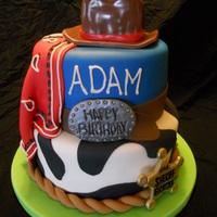 Cowboy Cake This cake was for a dad (Adam) and his one year old son (Brayden) and their birthdays. The hat is cake covered in fondant, and the buckles...