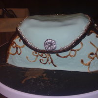 Handbag Cake Chocolate mud cake covered in chocolate ganache and teal fondant. The accents are in royal icing painted in chocolate. The finish product...