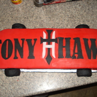 Skateboard Cake This was for my nephew's 8th birthday. He wanted a Tony Hawk skateboard. The wheels are RKT covered in fondant, the logo is fondant...
