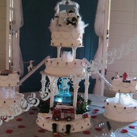 Firefighters Wedding this cake is 8",12" , 2 x 6",2 x 10" and a half 16 in front of fountain. hand made the ropes, ladders, fondant fire...