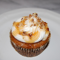 Carrot Cupcakes Carrot Cupcakes with cream cheese icing drizzled with caramel and pecans.