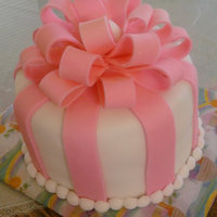 Tied Up With A Bow baby shower cake i made for my friend. the bows are made my looping strips of fondant and attaching them at the ends with water. let dry a...